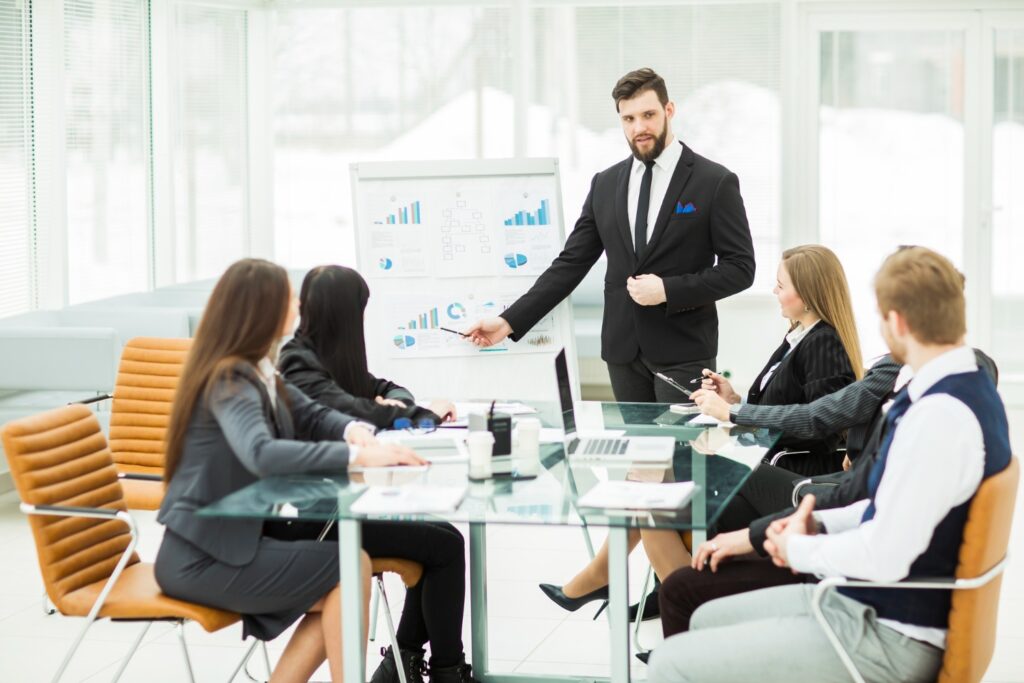 A businessman presenting to colleagues in a meeting room