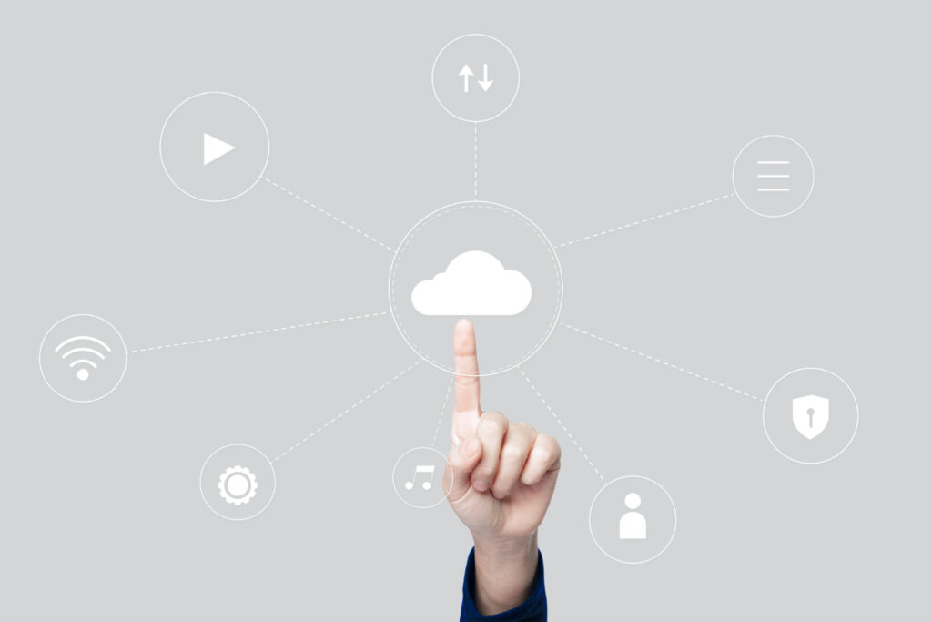 Hand touching cloud icon on gray background.