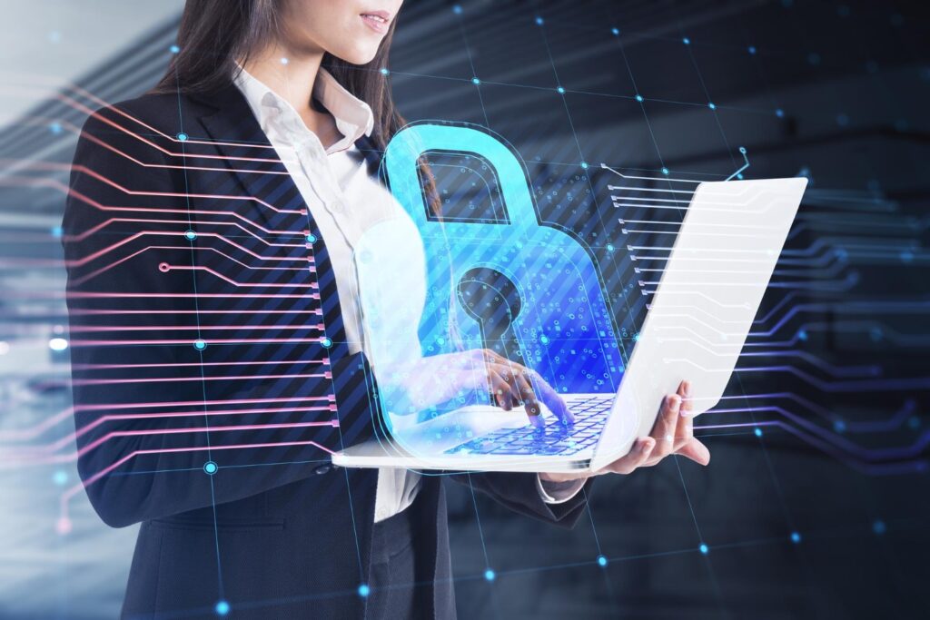 Businesswoman in suit holding laptop with padlock icon