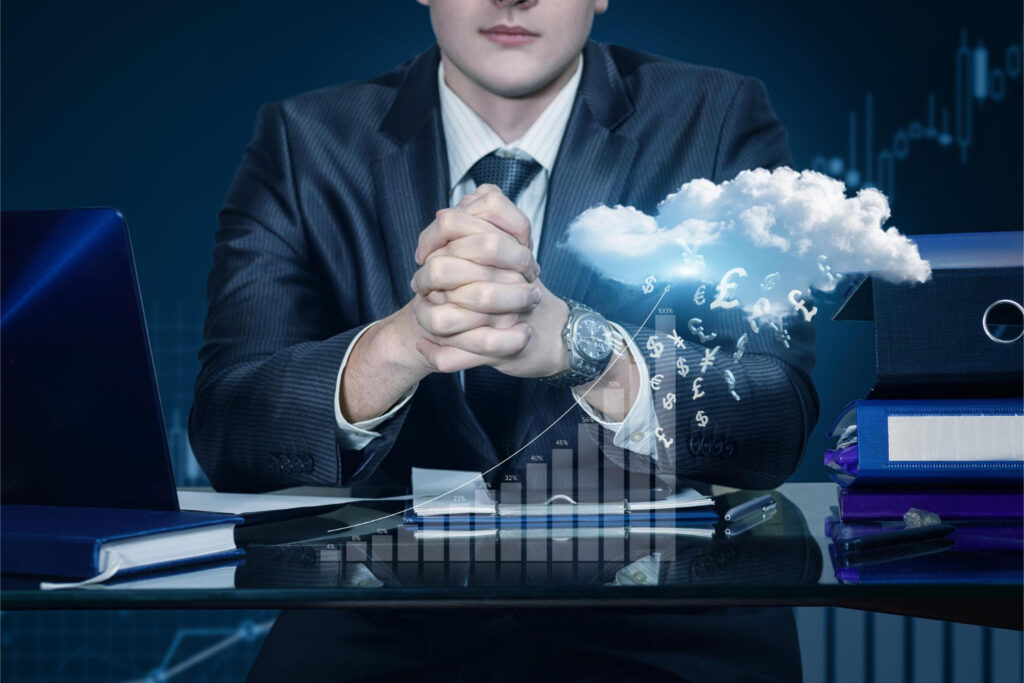 A businessman working on a laptop with Scalable and Cost-Effective Cloud computing technology in the background.