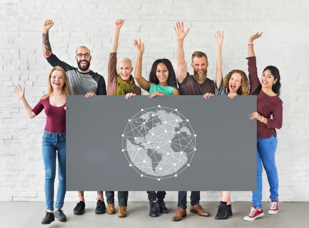 The diverse group of individuals holding a sign featuring a world map, advocating for Social Engineering Awareness Training