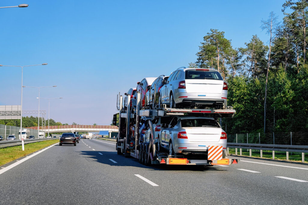 A car being transported on a flatbed truck.